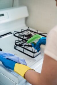 Oven interior being scrubbed during move‑out cleaning