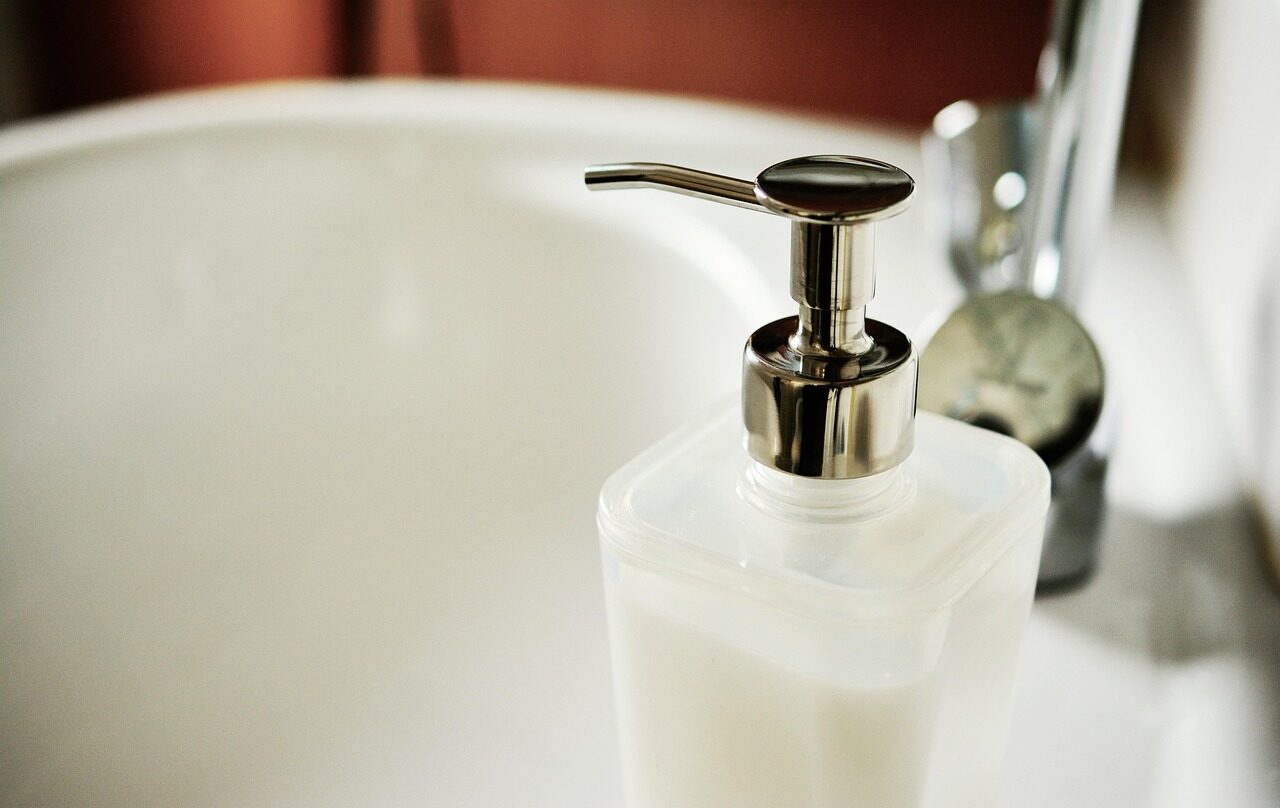 Cleaning professional scrubbing bathroom tile during deep cleaning